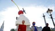 Deputy Mayor for Culture and Creative Industries Justine Simons OBE, Artist Heather Phillipson and Chair of the Fourth Plinth Comissioning Group Ekow Eshun pose next to Phillipson's sculpture ''THE END'', after it was unveiled on Trafalgar Square's Fourth