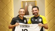 Al Sadd's latest recruit, Spanish star Santi Cazorla holding a team jersey with coach Xavi Hernandez during a ceremony held yesterday. The midfielder bid farewell to Villarreal few days ago. Cazorla had made 180 appearances over six years for Arsenal and 