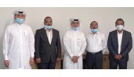 Senior officials of Al Ahed Holding pose for a photo in Doha, recently.