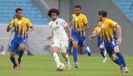 Al Sadd's Akram Afif in action against three Al Gharafa players during their Round 22 match yesterday.
