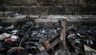 A cat is seen among burnt tents at the destroyed Moria camp for refugees and migrants, on the island of Lesbos, Greece, September 14, 2020. REUTERS/Alkis Konstantinidis 
