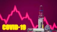 FILE PHOTO: A test tube labelled with the Vaccine is seen in front of Covid-19 and stock graph logo in this illustration taken, September 9, 2020. REUTERS/Dado Ruvic/Illustration/File Photo

