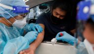 A healthcare worker takes blood sample from a passenger at a coronavirus disease (COVID-19) drive-thru testing center in Manila, Philippines, July 15, 2020. REUTERS/Eloisa Lopez/File Photo