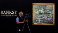 A television camera operator films an artwork entitled 