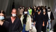 Models wearing protective masks are pictured during the rehearsal prior Fendi's Spring/Summer 2021 women's and mens collection during the Milan Fashion Week, on September 23, 2020. / AFP / MIGUEL MEDINA

