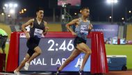 Morocco's Ilyass El Ouali and Qatar's Mohamed Al Garni in action during the men's 1500 metres Reuters/Ibraheem Al Omari