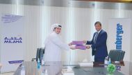 Senior officials from Milaha and Schlumberger Limited exchanging documents during the MoU signing ceremony held in Doha recently.