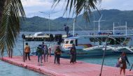 In this photo taken on October 1, 2020, residents arrive in Borocay, central Philippines. Authorities eased restrictions in the world-famous Boracay on October 1, allowing local tourists to visit the island after more than six months of quarantine as coro
