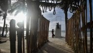 This picture taken on October 1, 2020 shows visitors taking pictures on a set of stairs on Patong beach in Phuket, which has seen a lack of tourists due to ongoing restrictions relating to the COVID-19 novel coronavirus. / AFP / Lillian SUWANRUMPHA