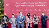 Qatar Racing and Equestrian Club CEO, Nasser bin Sherida Al Kaabi (centre) posing for a photograph with the winning team at St Cloud racetrack in France, yesterday.