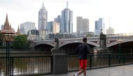 A man runs along a waterway after lockdown restrictions were implemented in response to an outbreak of the coronavirus disease (COVID-19) in Melbourne, Australia, July 10, 2020. REUTERS/Sandra Sanders/File Photo