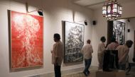 Visitors look at artworks by Ayman Baalbaki and Tagreed Darghouth during a collective exhibition entitled 