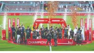 Al Sadd's players and officials celebrate withe the trophy after winning the Ooredoo Cup ?nal against Al Arabi at Al Duhail Stadium, yesterday.