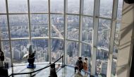 A family wearing masks to avoid the spread of the coronavirus disease (COVID-19) takes souvenir photos at the Seoul Sky Observatory in Seoul, South Korea, October 5, 2020. REUTERS/Kim Hong-Ji