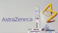 A test tube labeled with the vaccine is seen in front of AstraZeneca logo in this illustration taken, September 9, 2020. REUTERS/Dado Ruvic/File Photo