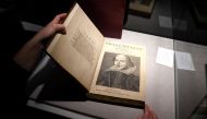 An employee of Christie's auctions holds a 1663 rare first folio of 36 Shakespeare works that was sold for a record 8.4 million dollars (9.978 million with buyers fee) in the Manhattan borough of New York City, New York, U.S., October 14, 2020. REUTERS/Ca
