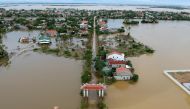 An aerial picture shows houses submerged in flood waters caused by heavy rains in Quang Dien district in central Vietnam's Hue province on October 15, 2020. / AFP / MANAN VATSYAYANA
