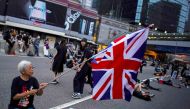 Alexandra Wong, 63, holds up a Union Flag during a demonstration demanding Hong Kong's leaders step down and withdraw an extradition bill, in Hong Kong, China, June 17, 2019. REUTERS/Athit Perawongmetha
