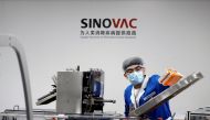 FILE PHOTO: A man works in the packaging facility of Chinese vaccine maker Sinovac Biotech, developing an experimental coronavirus disease (COVID-19) vaccine, during a government-organized media tour in Beijing, China, September 24, 2020. REUTERS/Thomas P