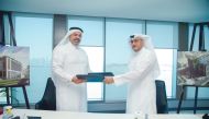 Qatar Cool CEO Yasser Al Jaidah (left) and Gulf Contracting Company’s Director Abdul Rahman Al Darwish exchanging documents after the contract signing ceremony yesterday.