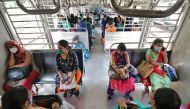Women wearing protective face masks commute in a suburban train after authorities resumed the train services for women passengers during non-peak hours, amidst the coronavirus disease (COVID-19) outbreak, in Mumbai, India, October 21, 2020. REUTERS/Nihari