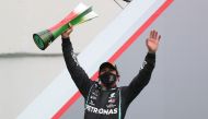Mercedes' Lewis Hamilton celebrates winning the race on the podium. (REUTERS/Jose Sena Goulao)