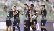Al Sadd's players celebrate with Hashim Ali (left). 