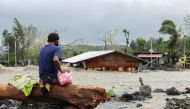 A man looks at his house buried under the pile of rubble and sand following flash floods brought by Typhoon 'Goni' in Barangay Busay, Daraga town, Albay province, Philippines, November 1, 2020. REUTERS/Nino N. Luces