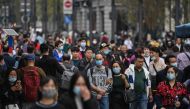 People walk along a pedestrian street in Shanghai on October 28, 2020. / AFP / Hector Retamal 