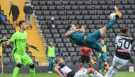 AC Milan's Swedish forward Zlatan Ibrahimovic (R) shoots and scores during the Italian Serie A football match between Udinese and AC Milan at the Friuli Stadium, alias 