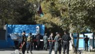 Policemen stand guard at an entrance gate of the Kabul University in Kabul on November 2, 2020. AFP / WAKIL KOHSAR