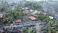 This aerial photo taken on November 2, 2020, shows houses buried by boulders and lahar washed from the slopes of nearby Mayon Volcano in Guinobatan town, Albay province, south of Manila, after super Typhoon Goni made landfall in the Philippines on Novembe