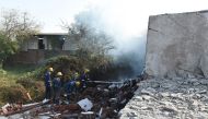 Ahmedabad and Emergency Services personnel put out a fire after a fire collapsed a garment wharehouse, on the outskirts of Ahmedabad on November 4, 2020. At least 9 people have been reported dead, according to local media. / AFP / SAM PANTHAKY

