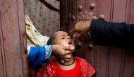 A girl receives polio vaccine drops, during an anti-polio campaign, in a low-income neighborhood as the spread of the coronavirus disease (COVID-19) continues, in Karachi, Pakistan July 20, 2020. REUTERS/Akhtar Soomro/File Photo