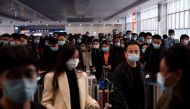 People wear face masks amid the global outbreak of the coronavirus disease (COVID-19) at Shanghai Railway Station in Shanghai, China, November 10, 2020. REUTERS/Aly Song