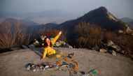 Kim Kang-Eun, an artist who leads Clean Hikers, poses artwork made from litter collected by members of Clean Hikers during their hikes, on the peak of a mountain in Incheon, South Korea, November 16, 2020. Reuters/Kim Hong-Ji