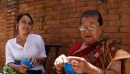 In this picture taken on August 6, 2020, business woman Lorina Sthapit (L) looks at her grandmother Champa Devi Tuladhar during an interview with AFP in Kathmandu. AFP / Prakash Mathema 