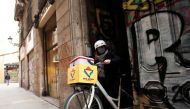 Geraldine Caillaud, member of the bicycle delivery company Les Mercedes, leaves their office with a bicycle at Barcelona's city center, during the COVID-19 pandemic, Spain, December 17, 2020. Picture taken December 17, 2020. Reuters/Albert Gea