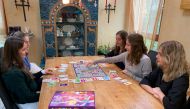 Rebecca, Lara, Stella, Sarah und Paulette Schwaderlapp play 'Corona - the rush to the shops' board game invented by Lara and Sarah to pass away the time in lockdown, in Wiesbaden Biebrich, Germany, December 20, 2020. Reuters/Annkathrin Weiss