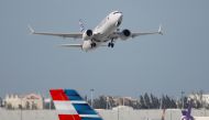 FILE PHOTO: American Airlines flight 718, the first U.S. Boeing 737 Max commercial flight since regulators lifted a 20-month grounding in November, takes off from Miami, Florida, U.S. December 29, 2020. REUTERS/Marco Bello/File Photo
