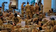 National Guard members gather and rest, before Democrats begin debating one article of impeachment against U.S. President Donald Trump at the U.S. Capitol, in Washington, U.S., January 13, 2021. REUTERS/Joshua Roberts
