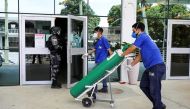 A worker arrives with an oxygen cylinder at Getulio Vargas hospital, amid the coronavirus disease (COVID-19) outbreak in Manaus, Brazil January 14, 2021. REUTERS/Bruno Kelly
