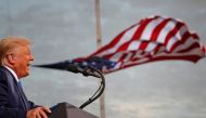 President Donald Trump speaks, with a flag behind him, during a campaign rally at Cecil Airport in Jacksonville, Florida, September 24, 2020. REUTERS/Tom Brenner/File Photo/File Photo