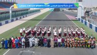 The participating riders, drivers and officials posing for a photograph before the opening round of the races at the Losail International Circuit yesterday.
