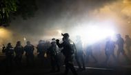 Portland Police officers disperse a crowd of protesters using CS gas and less lethal munitions on the 100th consecutive night of protests in Portland, Oregon, U.S. September 5, 2020. Picture taken September 5, 2020. Reuters/Caitlin Ochs