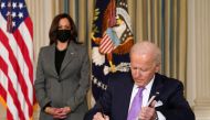 U.S. Vice President Kamala Harris watches as President Joe Biden signs executive orders on his racial equity agenda at the White House in Washington, U.S., January 26, 2021. REUTERS/Kevin Lamarque
