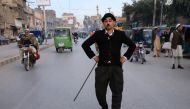 Usman Khan, 29, dressed up as Charlie Chaplin, performs along the street in Peshawar, Pakistan January 27, 2021. Picture taken January 27, 2021. Reuters/Fayaz Aziz