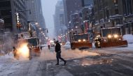 Snow plows wait at a traffic light on 8th Avenue during a snow storm, during the coronavirus disease (COVID-19) pandemic in the Manhattan borough of New York City, New York, U.S., February 1, 2021. REUTERS/Caitlin Ochs
