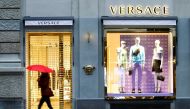 A pedestrian walks past a closed store of the Italian fashion house Versace at the Bahnhofstrasse shopping street in Zurich, during a partial lockdown as the spread of the coronavirus disease (COVID-19) continues in Switzerland February 3, 2021. REUTERS/A