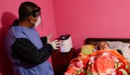 A health worker gives instructions to Silvia Luna Galvan, a patient suffering from coronavirus disease (COVID-19), at her home as she uses an oxygen concentrator, as part of a program for patients, at the Iztapalapa neighborhood in Mexico City, Mexico Feb